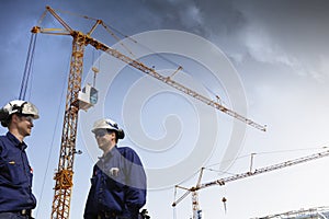Construction cranes and building workers