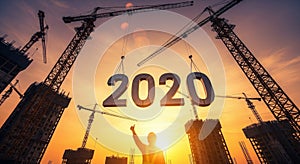 Construction Cranes Building the Year 2020 at Sunset