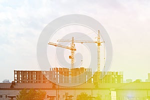 Construction cranes, construction site. Housing construction, apartment block in city. Copy Space