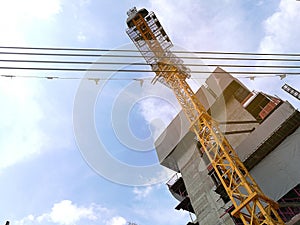 Construction cranes machine against sky background. Under construction.