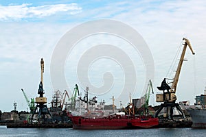 Construction cranes and ships in the port of Lithuania