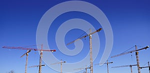 Construction cranes view over blue sky