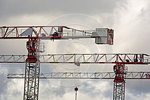 Construction cranes work at a construction site
