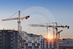 Construction cranes work in thef Helsinki in winter