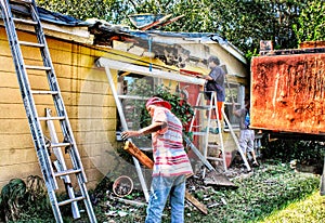 Construction  crew dismantles a  porch during a roofing job