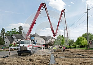 Construction Crew Pumping Concrete into Housing Development Footer photo