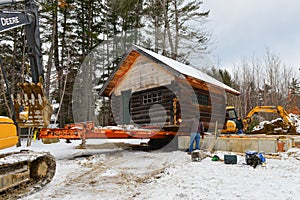 Construction crew unloading log cabin