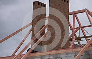 Construction crew working on the roof against blue sky