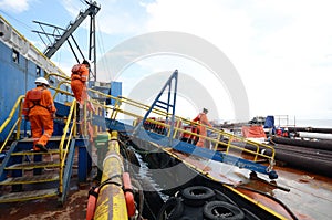 Construction crews crossing gangway to cargo barge