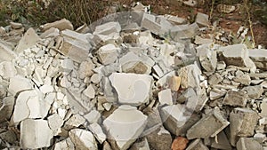 Construction debris on site with broken panels and bricks, closeup view.