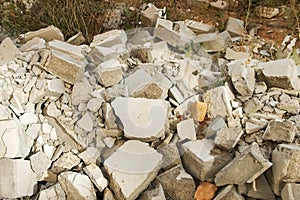 Construction debris on site with broken panels and bricks, closeup view.