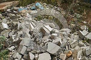 Construction debris on site with broken panels and bricks, closeup view.