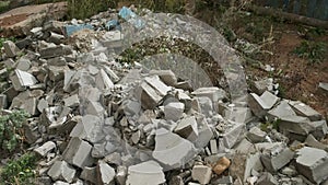 Construction debris on site with broken panels and bricks, closeup view.