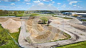Construction deconstruction zone area grass field, stone gravel pile aerial