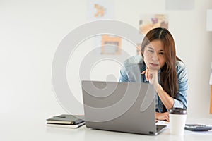 Construction design concept, Female architect use calculator and looks house plan project on laptop