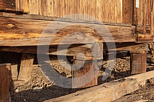 Construction detail of wood piers and beams supporting an old building, American Southwest