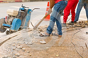 Construction drilling repair worker on road surface with heavy duty machine drill motion