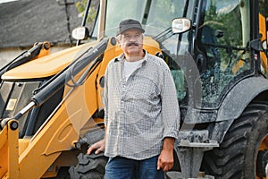 Construction driver with excavator on the background