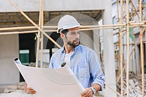 Construction engineer builder work in construction site. Architect home project foreman chief designer working with floor plan