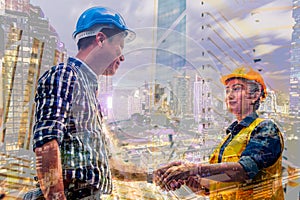 Construction and engineer concept. Construction worker in protective uniform shaking hands meeting for architectural project