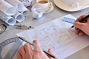 Construction engineer drawing a house on his office desk