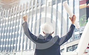 Construction engineer man hold blueprint wear blue shirt safety white hard hat at construction site industry labor worker.