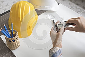 Construction engineer measuring with vernier caliper. Business a