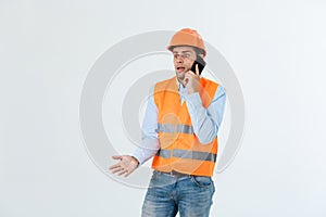 Construction engineer talking on mobile phone, serious adult male person using smartphone for communication with workers