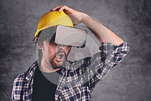 Construction engineer with VR goggles managing building project