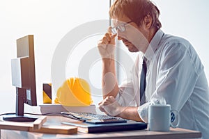 Construction engineer working on desktop computer using CAD soft