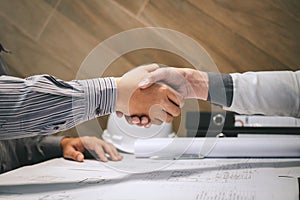 Construction engineering or architect discuss a blueprint while checking information on drawing and sketching, meeting for