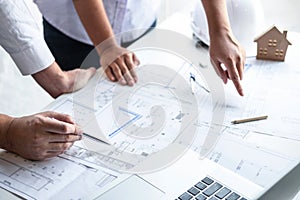 Construction engineering or architect discuss a blueprint while checking information on drawing and sketching meeting for