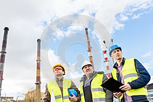 Construction engineers examining thermoelectric power station.