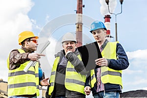 Construction engineers examining thermoelectric power station.