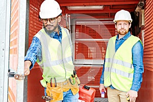 Construction engineers in industrial elevator