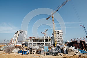 construction equipment and construction debris on the site in front of the houses