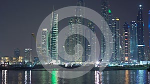 Construction equipment, excavator works at night. Nightly Dubai preparing to Expo 2020, building construction. View from