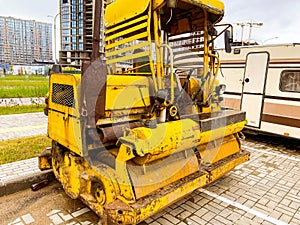 Construction equipment on site. construction of houses in a new microdistrict from blocks and glass. yellow construction equipment