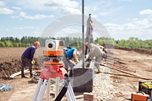 Construction equipment. Surveyors equipment theodolite on the construction site. Monitoring the progress of construction work