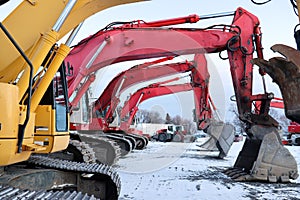 Construction excavator machines preparing to dig