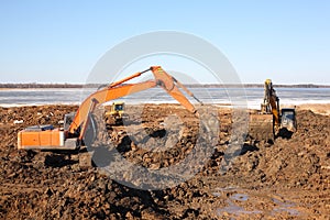 Construction - Excavators and bulldozer work in dirt