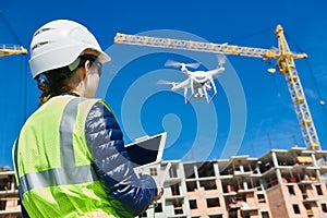 Drone inspection. Operator inspecting construction building site flying with drone photo