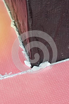 Construction foam between pink extruded styrofoam sheets