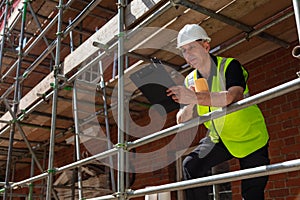 Construction Foreman Builder on Building Site With Clipboard