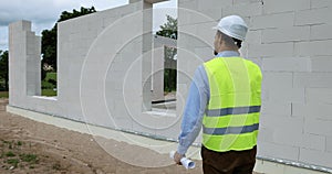 Construction foreman talking on the mobile phone at building site