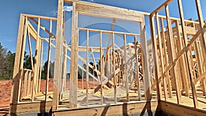 Construction frame house of wooden beam framework on stick new build home