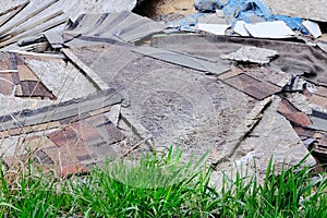 Construction garbage, cardboard, plywood after destruction of small buildings. Removal of debris. Bunch of trash on nature