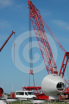 Construction of the gigantic construction crane together with a mobile crane for building a wind turbine