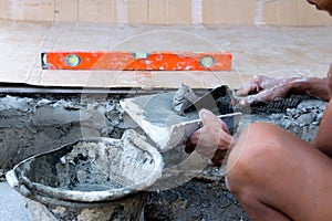 Construction hand holding trowel plastering concrete
