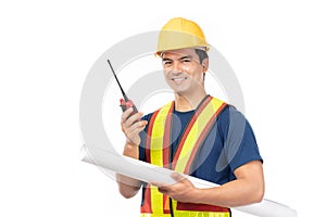 Construction handsome man worker in yellow helmet and reflective vest and using walkie talkie for talking with team staff isolated